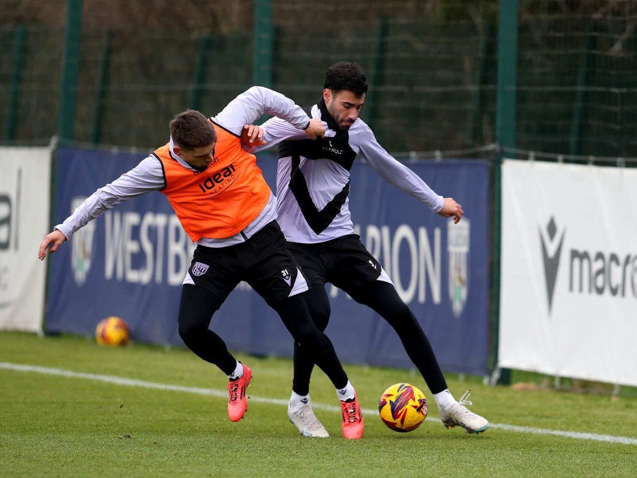 Tom Fellows and Gianluca Frabotta battling for the ball during a training session