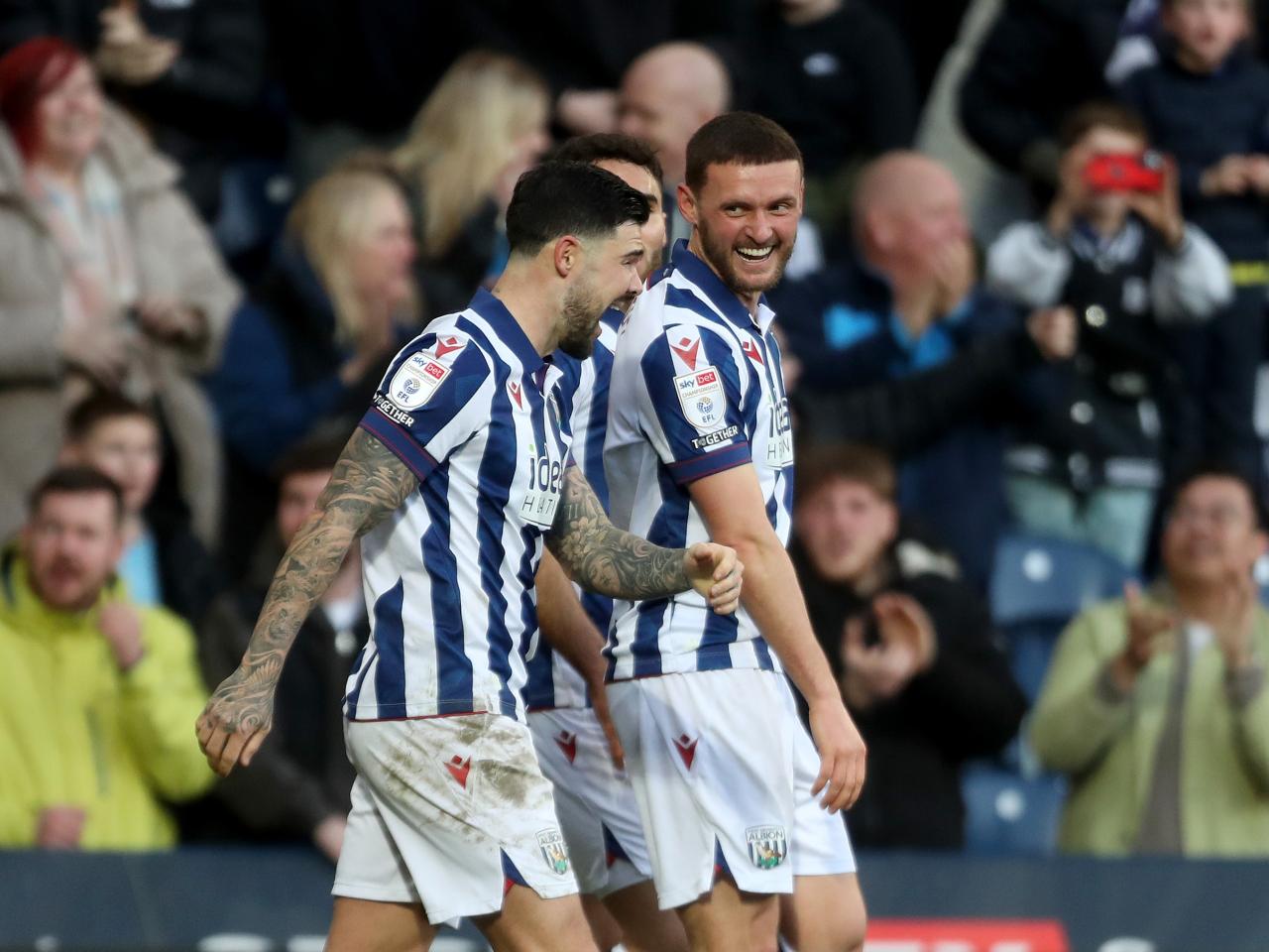 John Swift celebrates scoring against Oxford at The Hawthorns