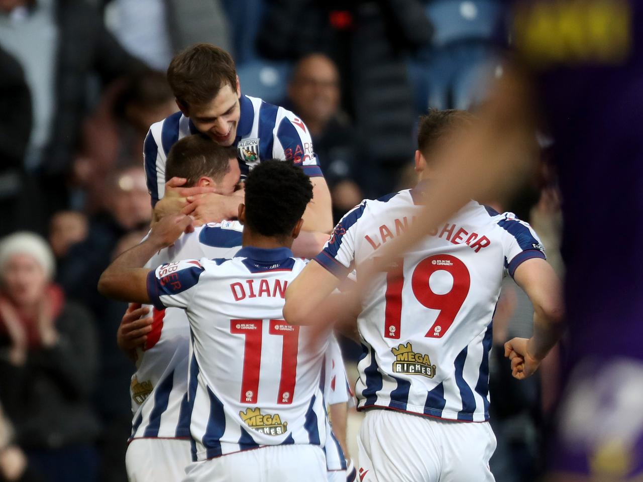 John Swift celebrates scoring against Oxford at The Hawthorns with team-mates