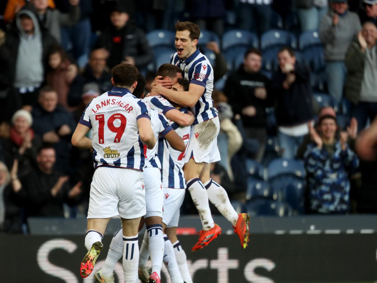 John Swift celebrates scoring against Oxford at The Hawthorns with team-mates