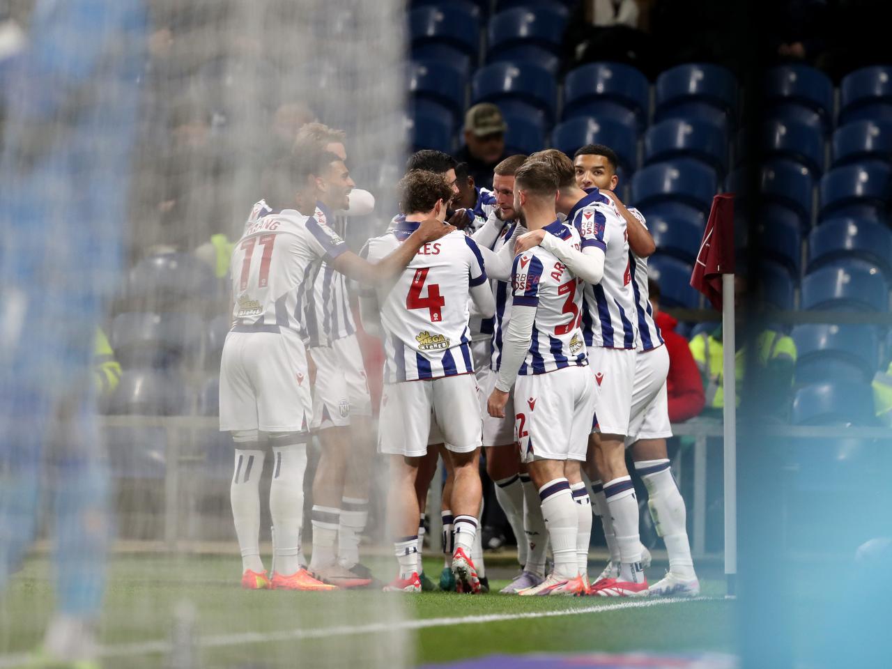 John Swift celebrates scoring a free-kick at Burnley with team-mates