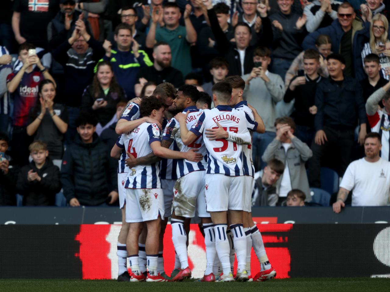Adam Armstrong is mobbed by team-mates after scoring against QPR 