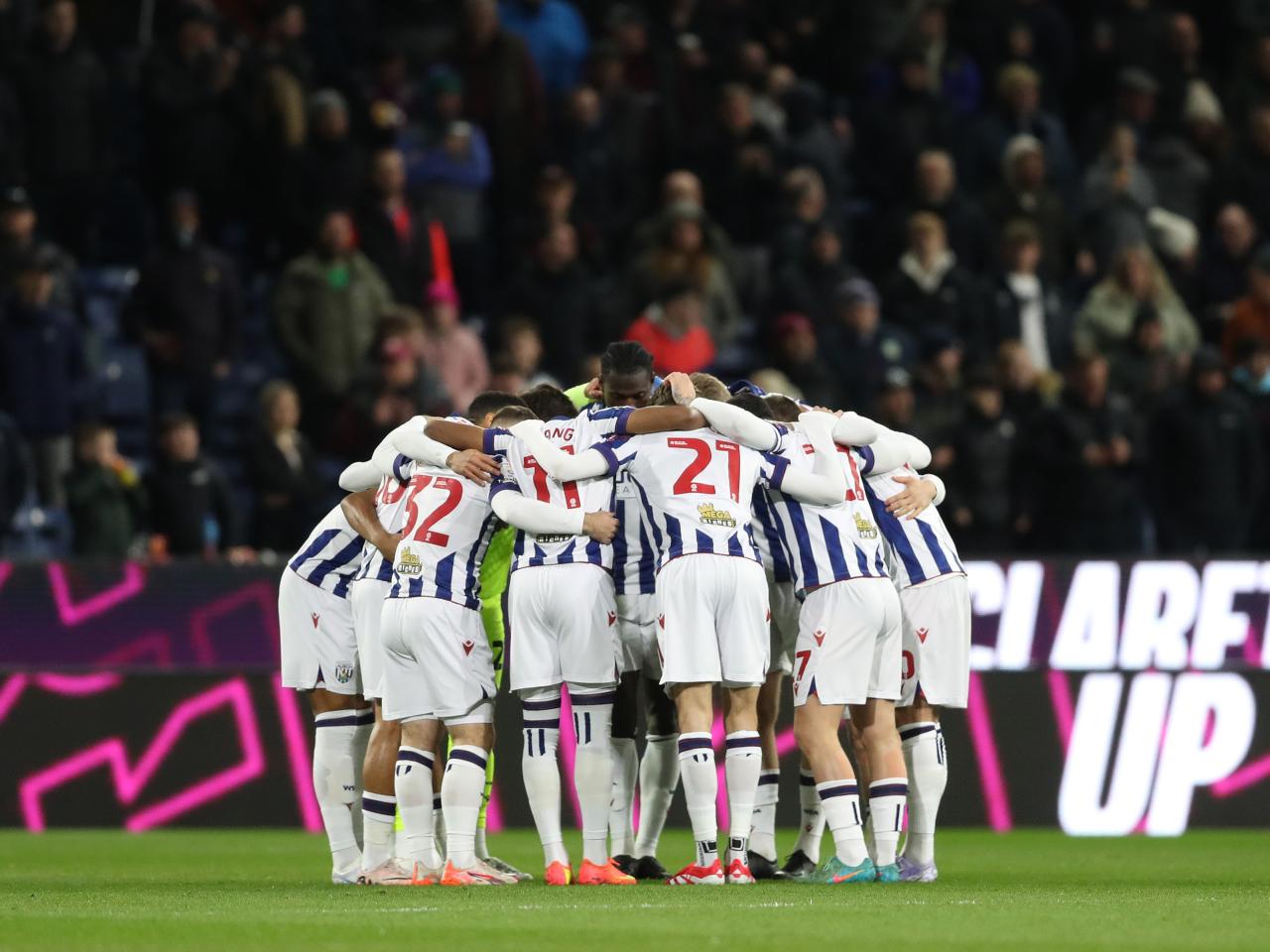 Albion team at Burnley in a pre-match huddle on the pitch