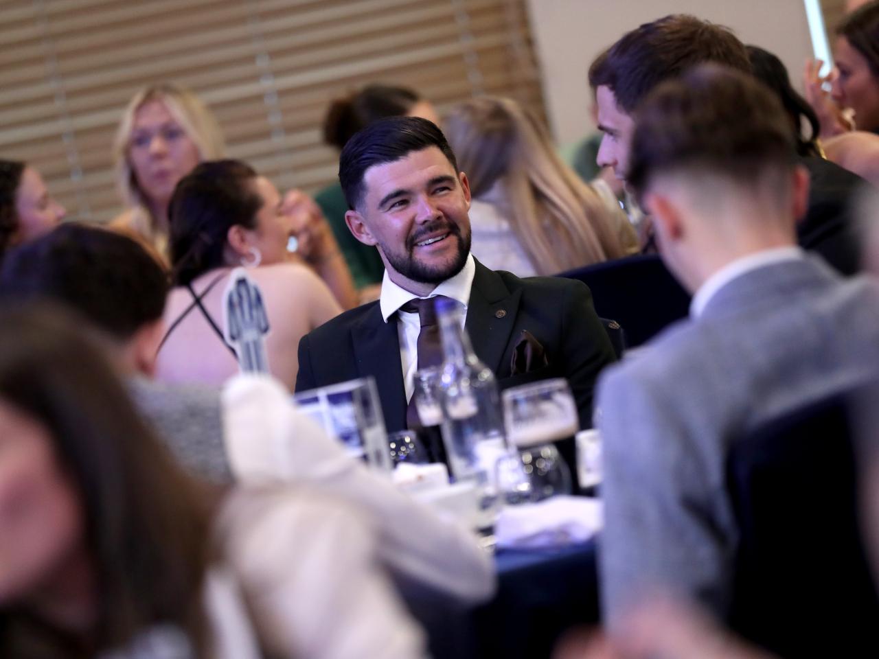 Alex Mowatt sat at a table at the end of season awards dinner