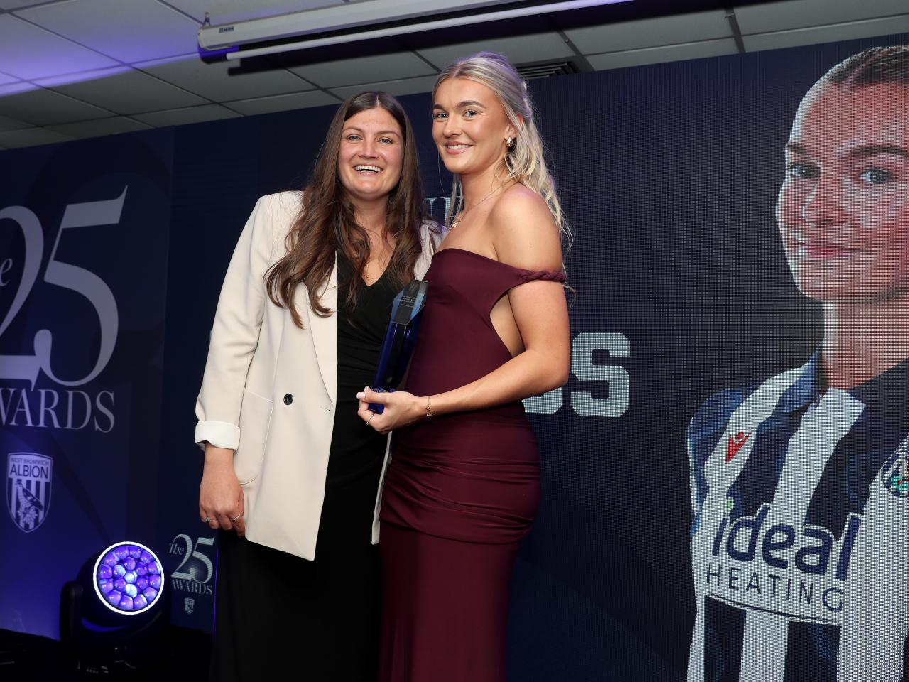 Siobhan Hodgetts-Still poses for a photo with Taylor Reynolds on stage at the end of season awards dinner