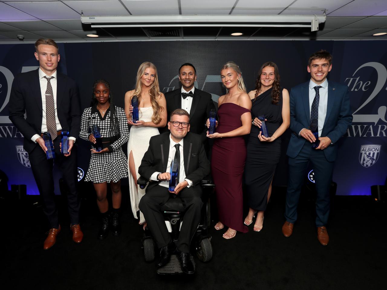 Shilen Patel poses for a photo with all the awards winners on stage at the end of season awards dinner