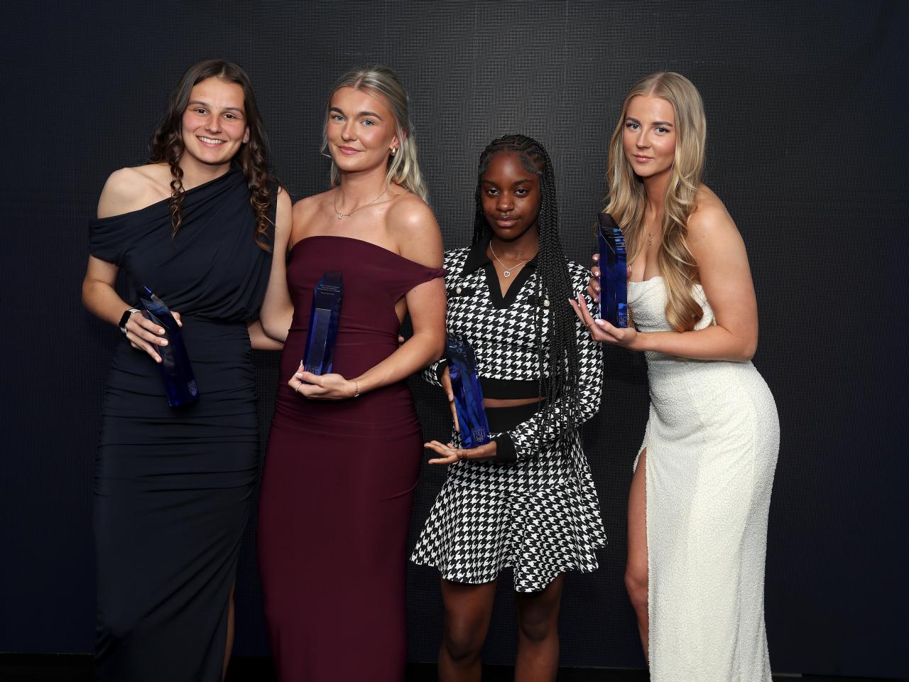 Four Albion Women awards winners pose on stage with their trophies at the end of season awards night