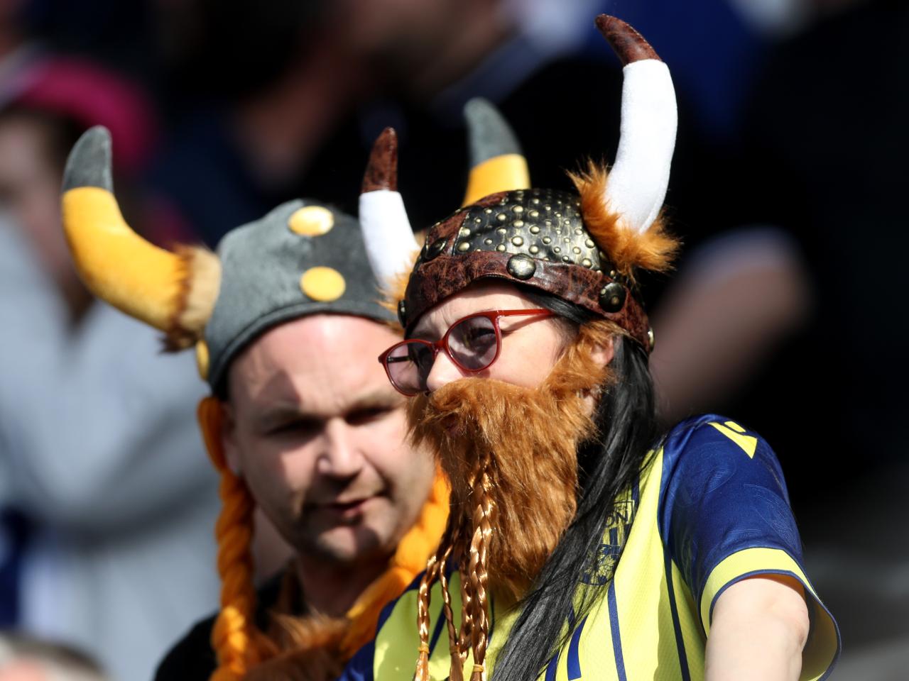 Two Albion fans in the away end wearing viking hats