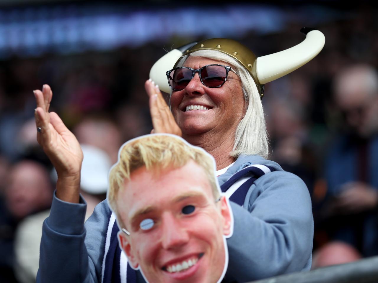 An Albion fan with a Torbjørn Heggem mask in the away end 