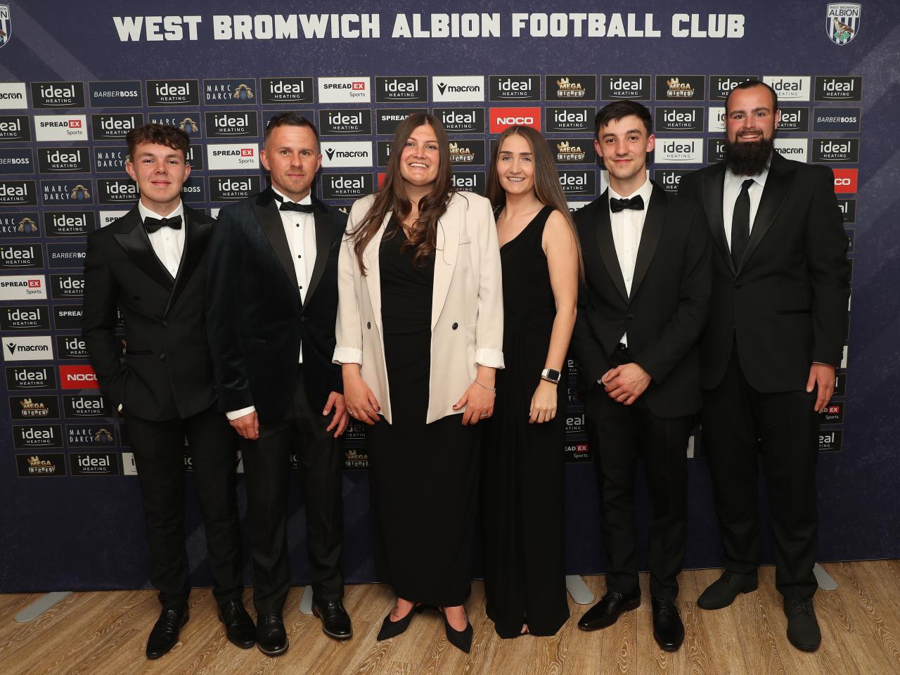Siobhan Hodgetts-Still posing for a photo on stage with Albion Women staff at the end of season awards dinner