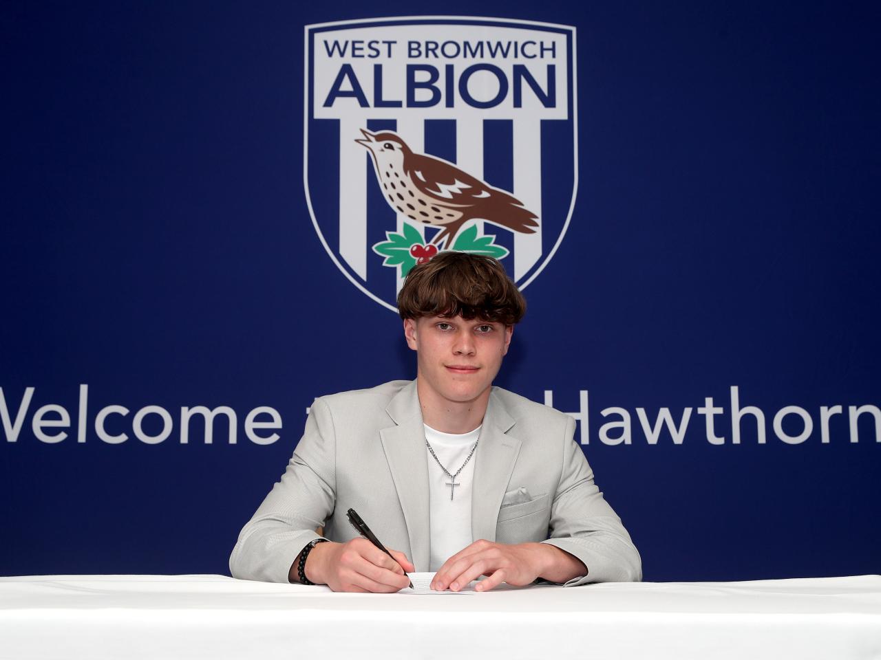 A photo of Albion scholar Alfie Round signing scholarship terms ahead of the 2025/26 season