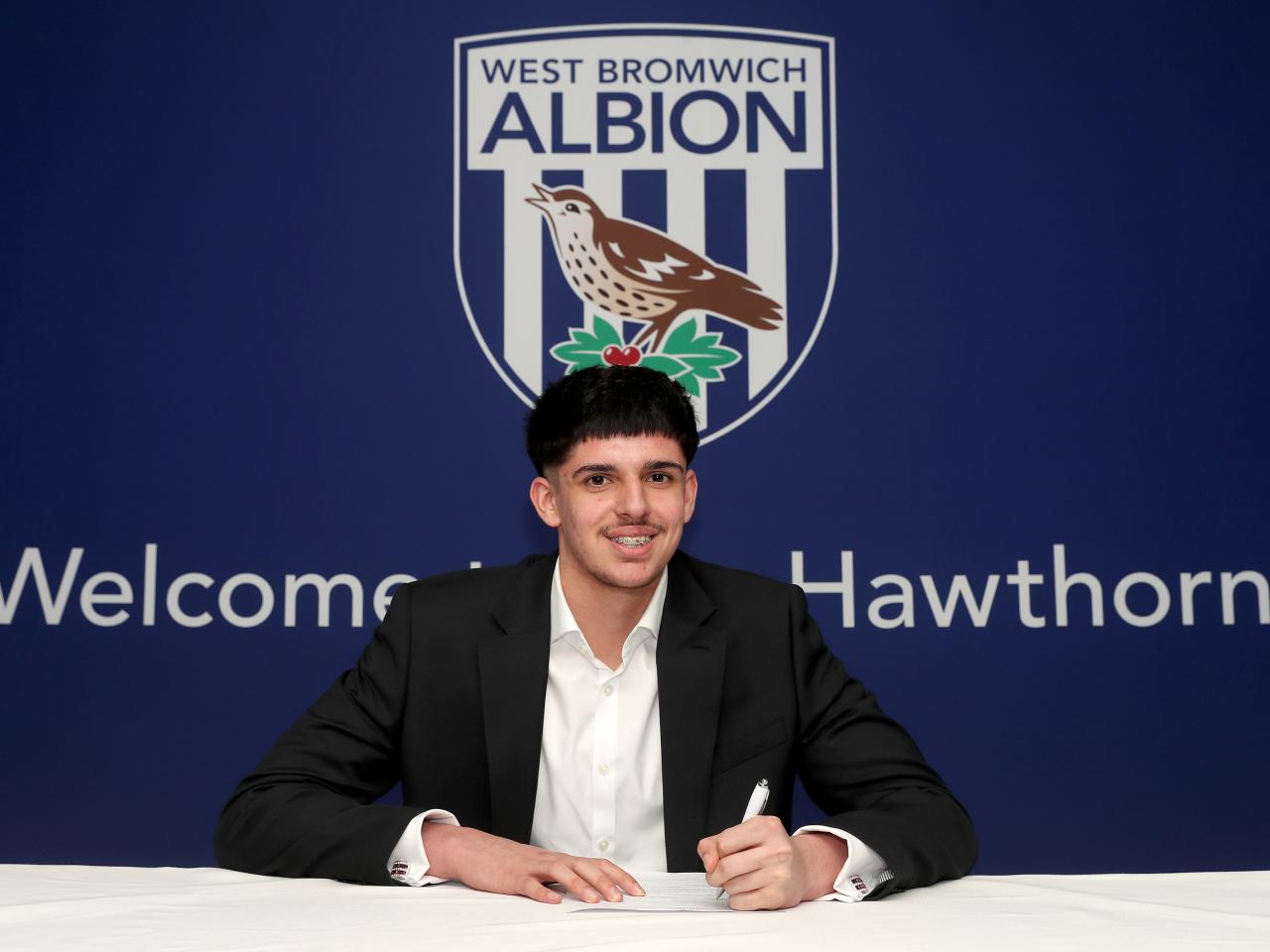 A photo of Albion scholar Danyal Iqbal signing scholarship terms ahead of the 2025/26 season