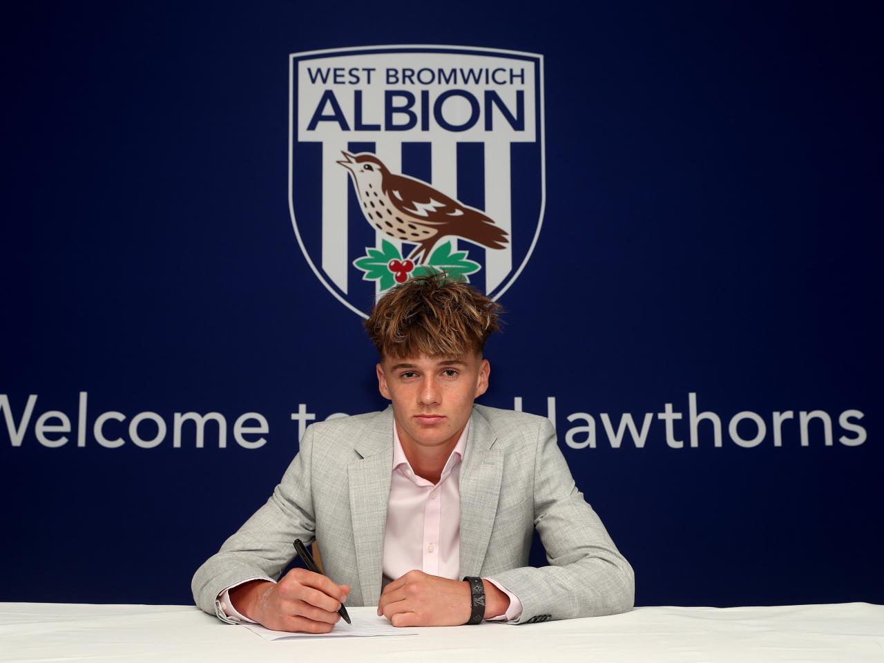 A photo of Albion scholar Harry French signing scholarship terms ahead of the 2025/26 season
