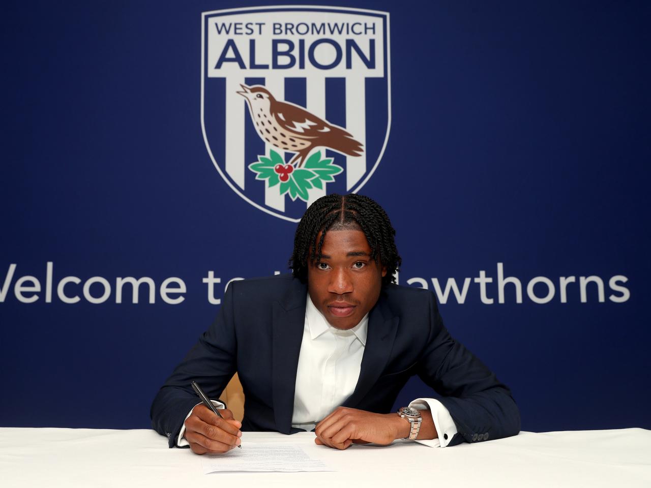 A photo of Albion scholar Joel Asomugha signing scholarship terms ahead of the 2025/26 season