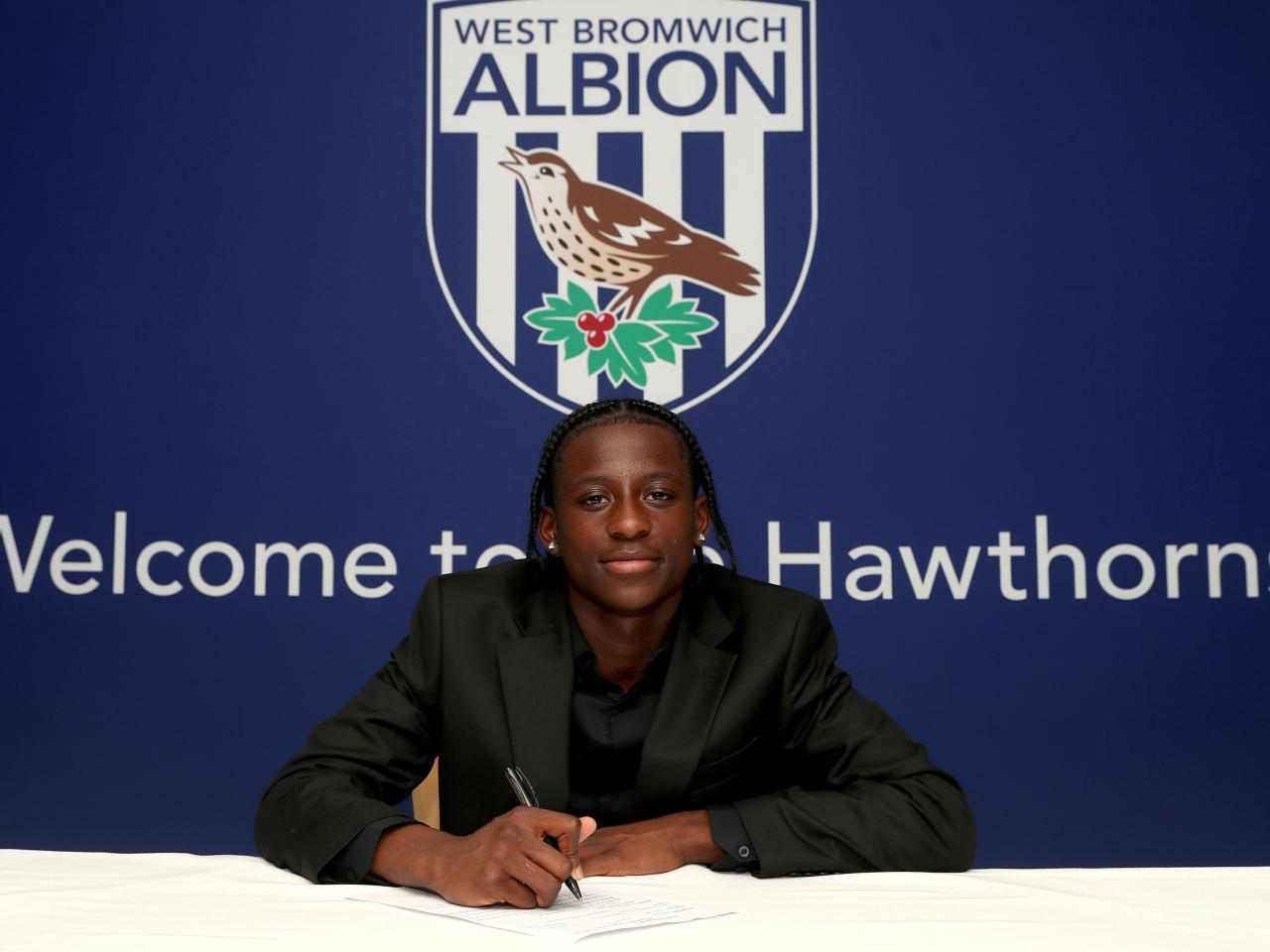 A photo of Albion scholar Shane Gompe signing scholarship terms ahead of the 2025/26 season