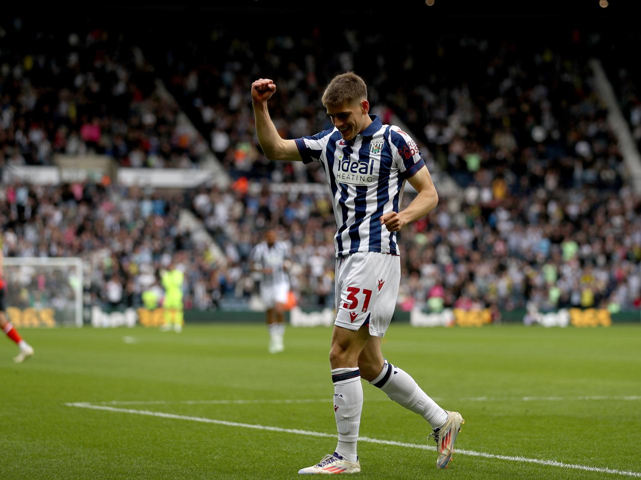 Tom Fellows celebrates alone after scoring against Luton Town
