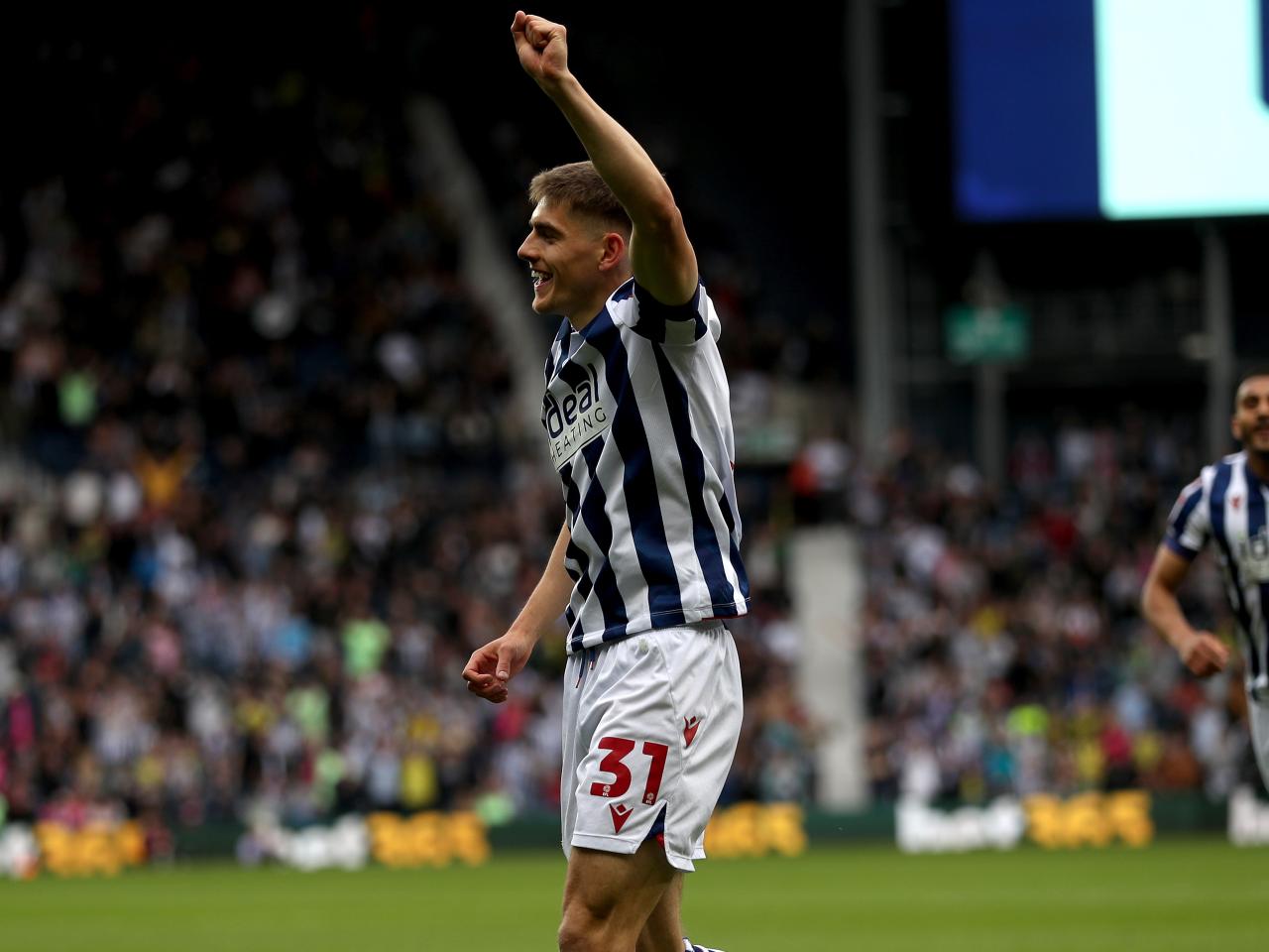 Tom Fellows celebrates alone after scoring against Luton Town
