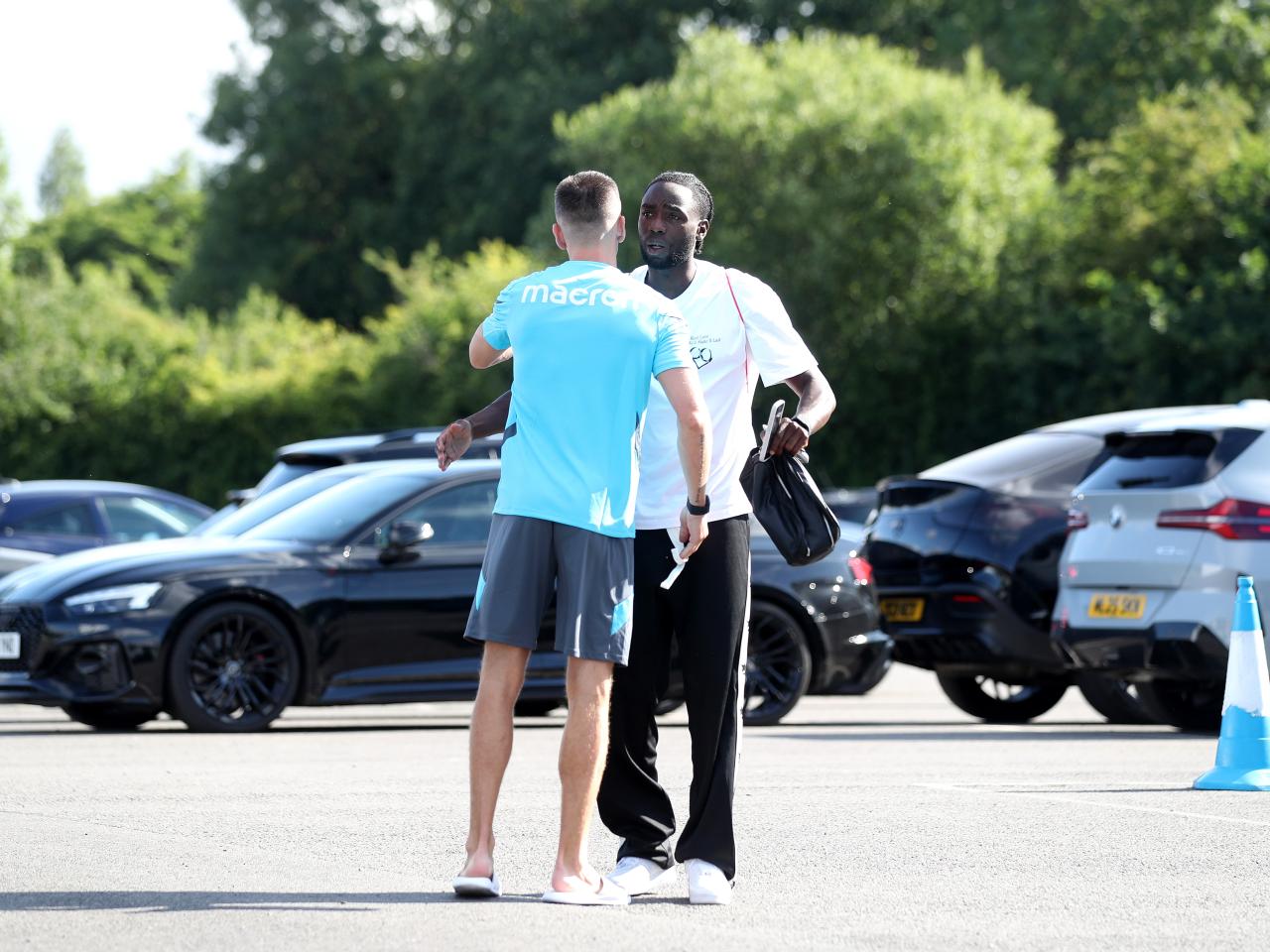 Jed Wallace greeting Devante Cole at the training ground on the first day of pre-season