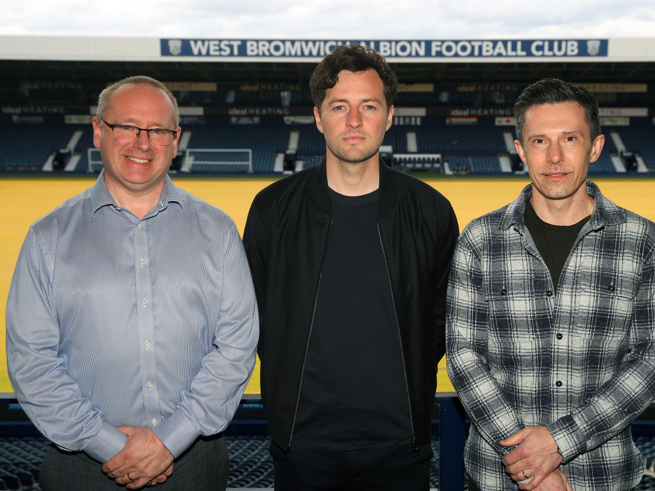 Mark Miles, Ryan Mason and Andrew Nestor posing for a photo at The Hawthorns with the West Stand behind them