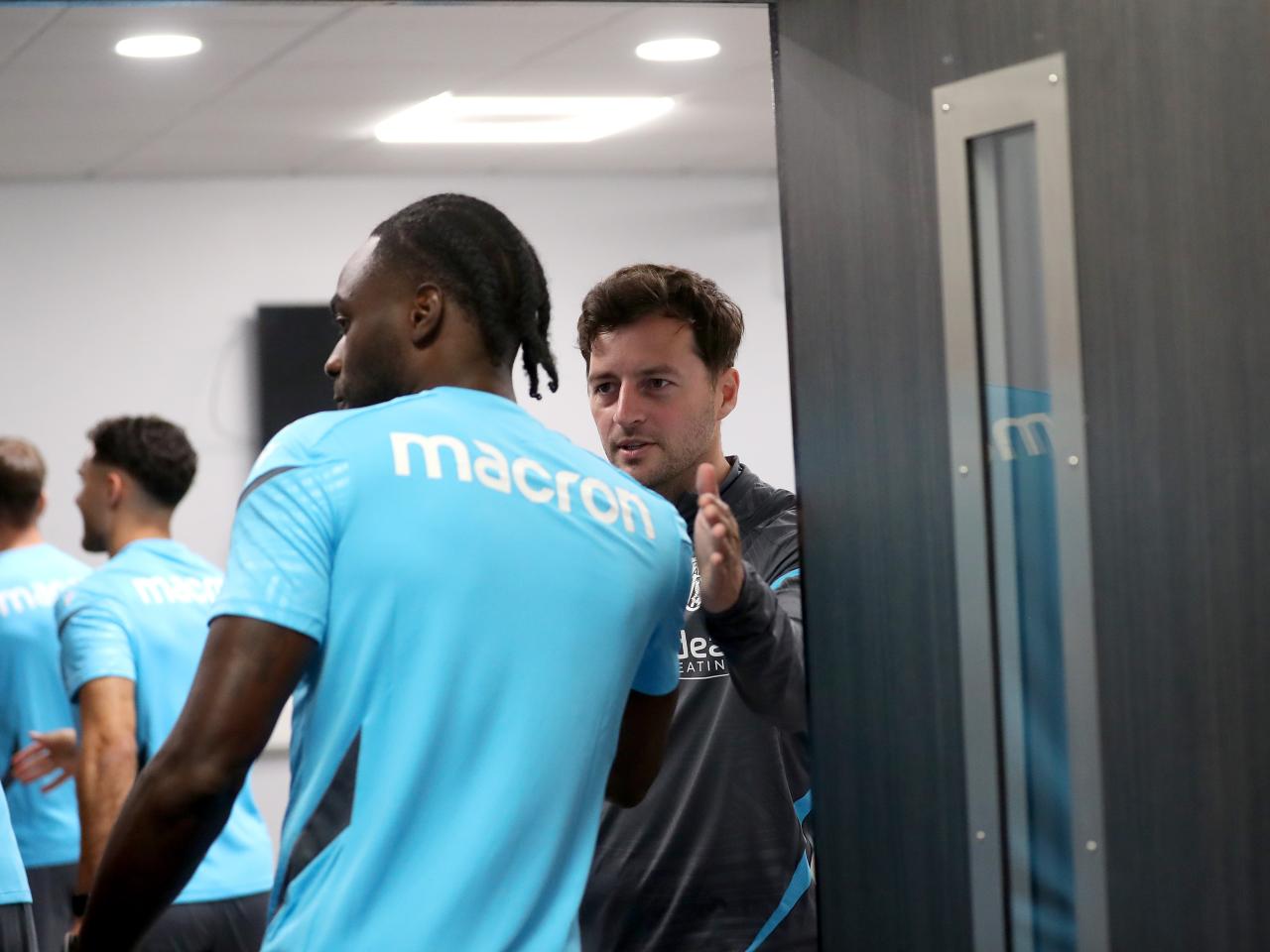 Ryan Mason greeting Albion players before a meeting