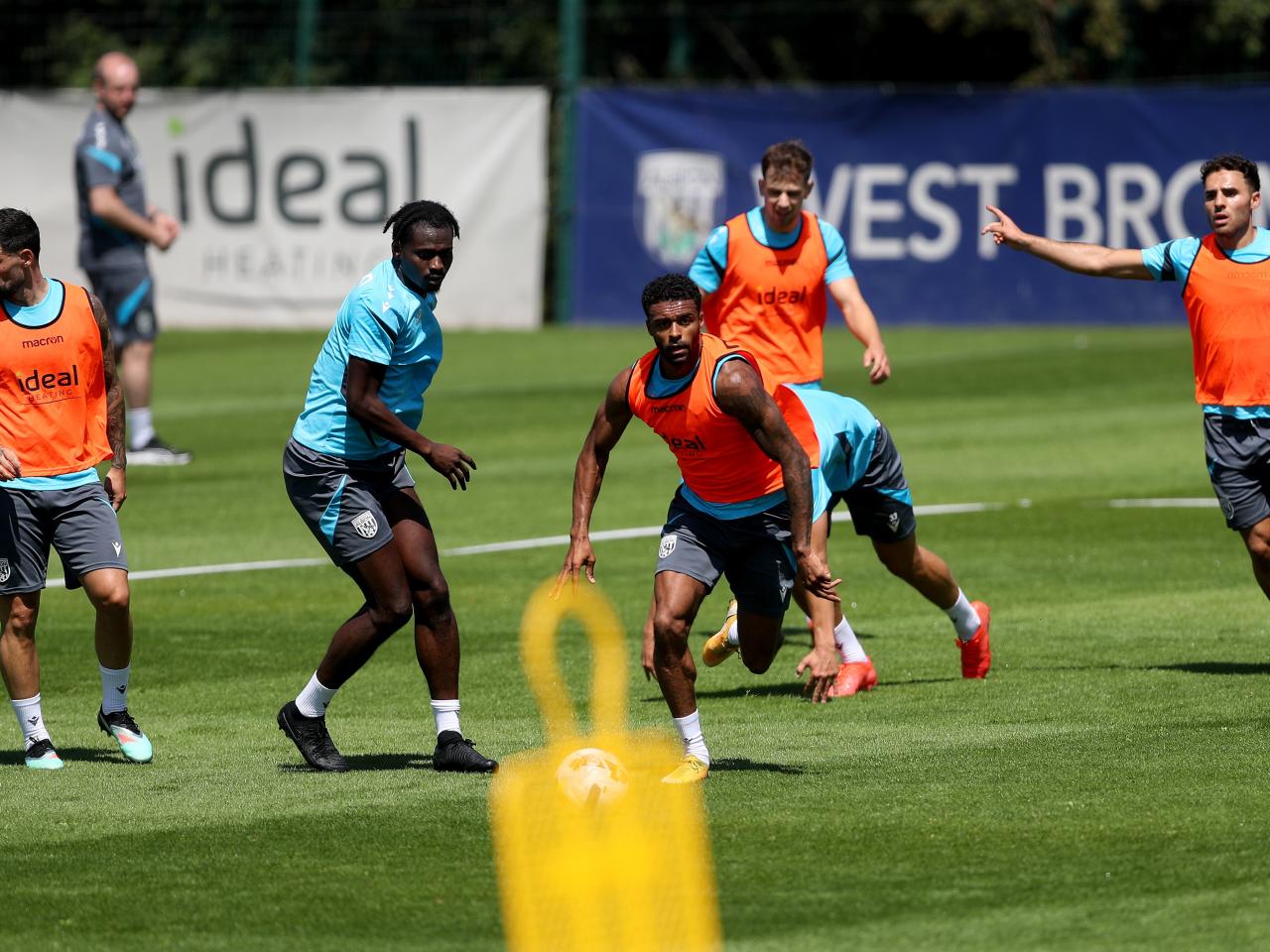 Darnell Furlong running away with the ball during a training session with several players around him