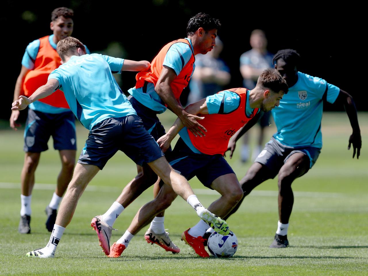 Several players battling for the ball during a training session