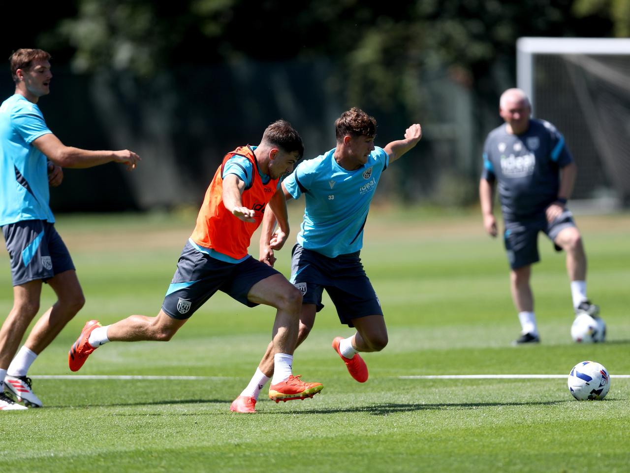 Jayson Molumby and Cole Deeming battling for the ball during a training session