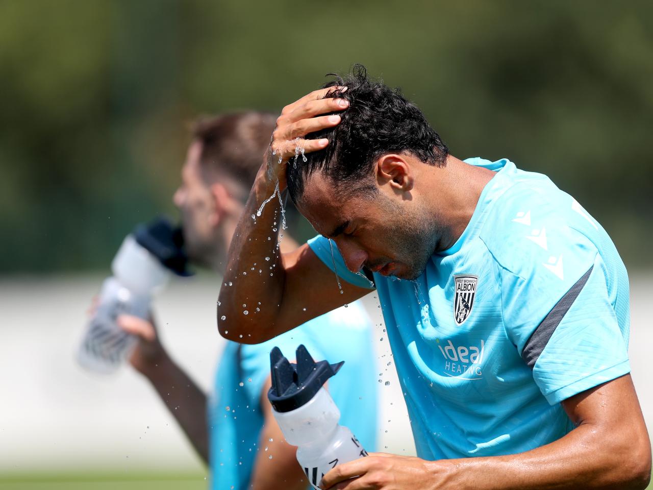 Gianluca Frabotta squirting water into his face during a break in the training session