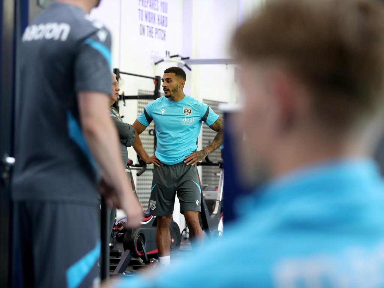 Karlan Grant stood chatting in the gym with his hands on his hips