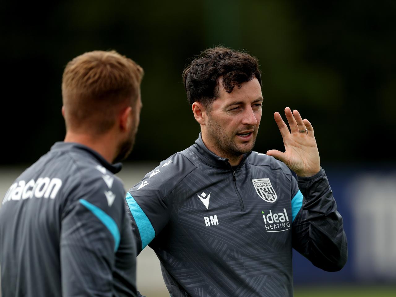 Ryan Mason watching training and talking to James Morrison