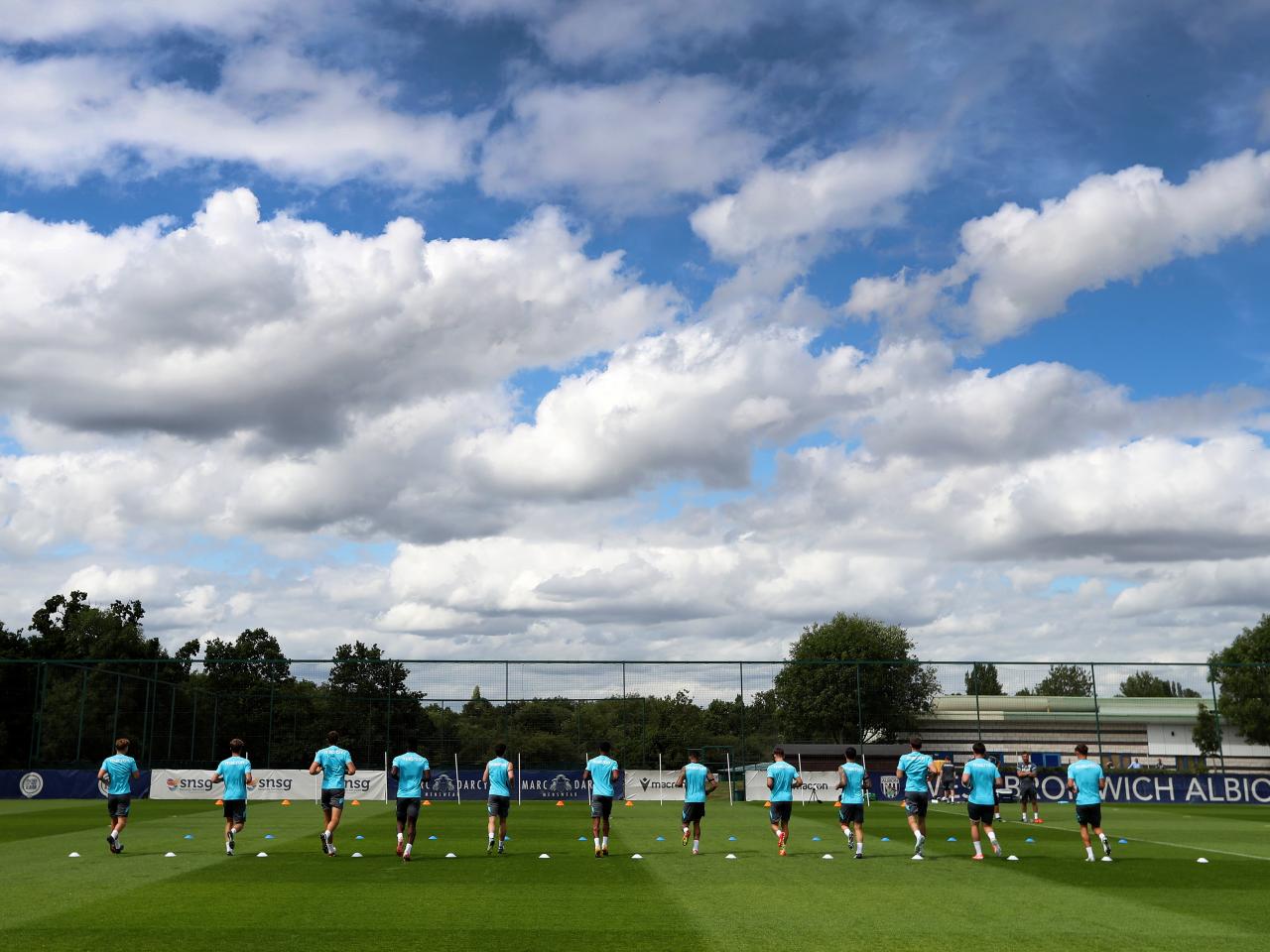 Several Albion players jogging during a training session