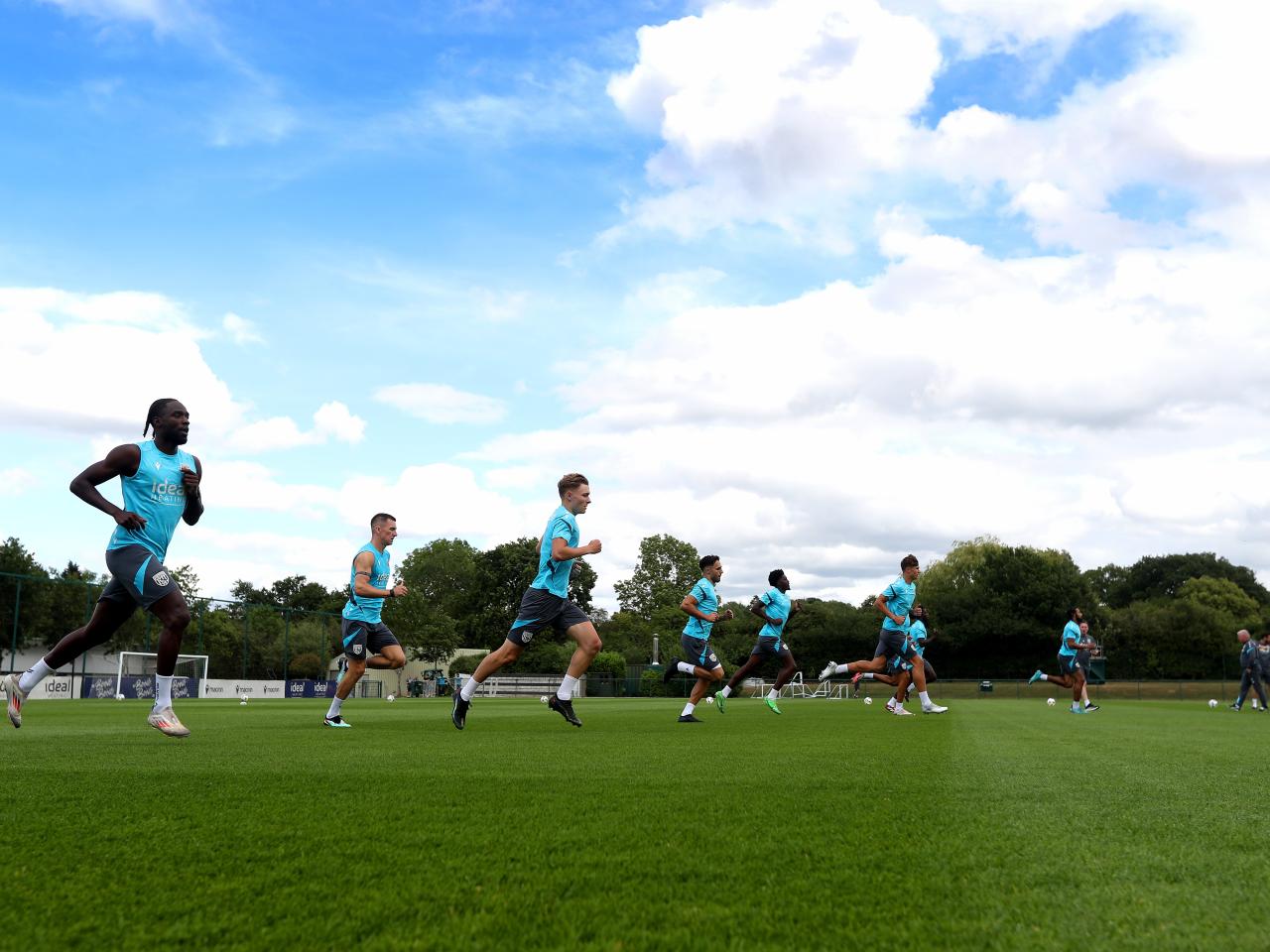 Several Albion players jogging during a training session