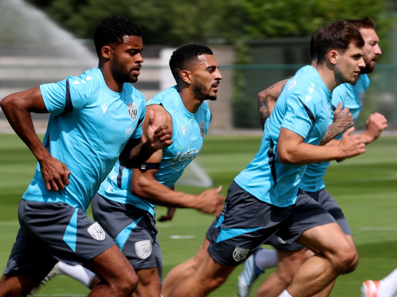 Several Albion players jogging during a training session