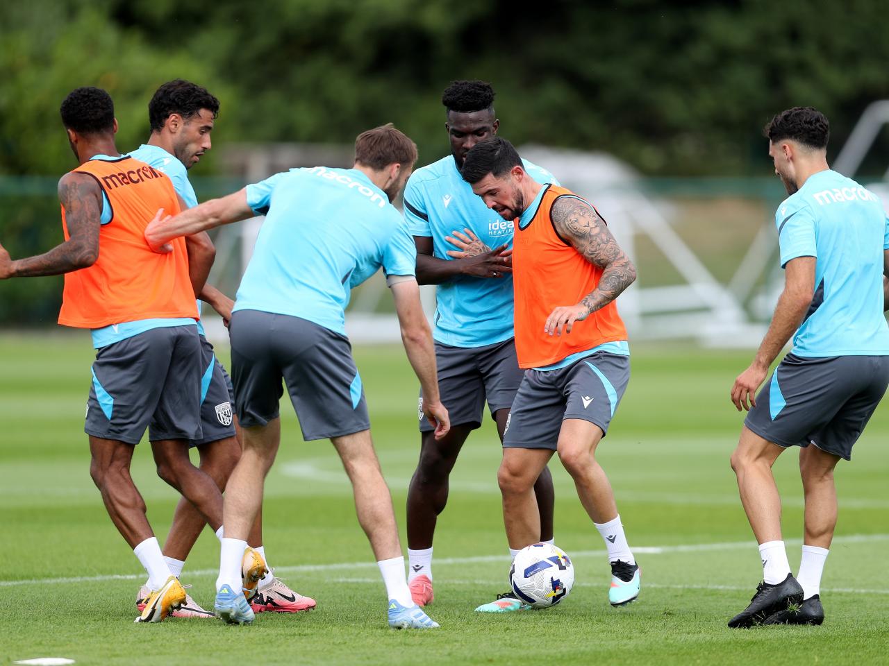 Alex Mowatt on the ball during a training session with several players around him