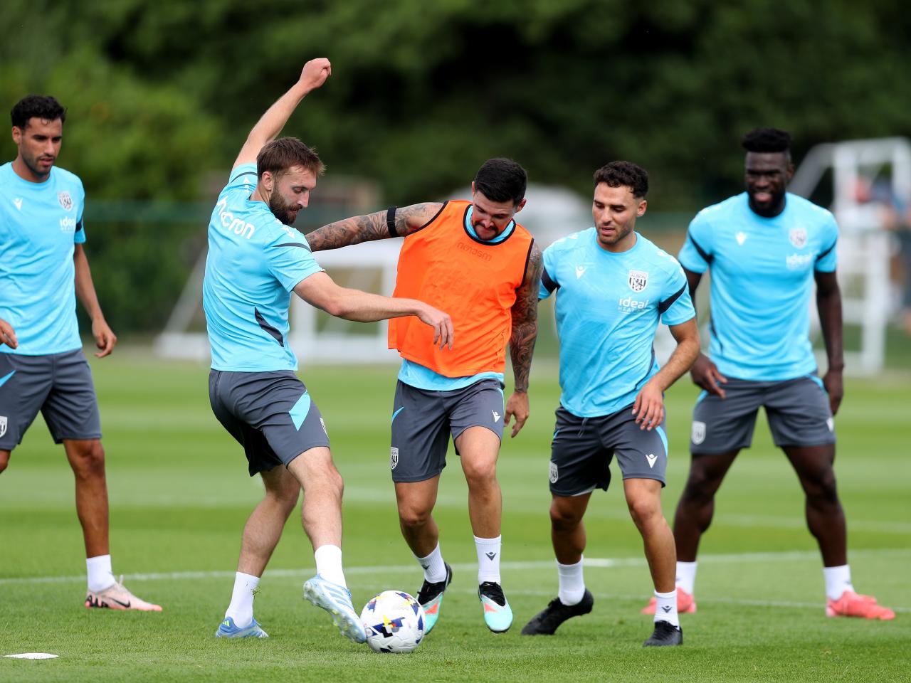 Nat Phillips and Alex Mowatt battle for the ball during a training session