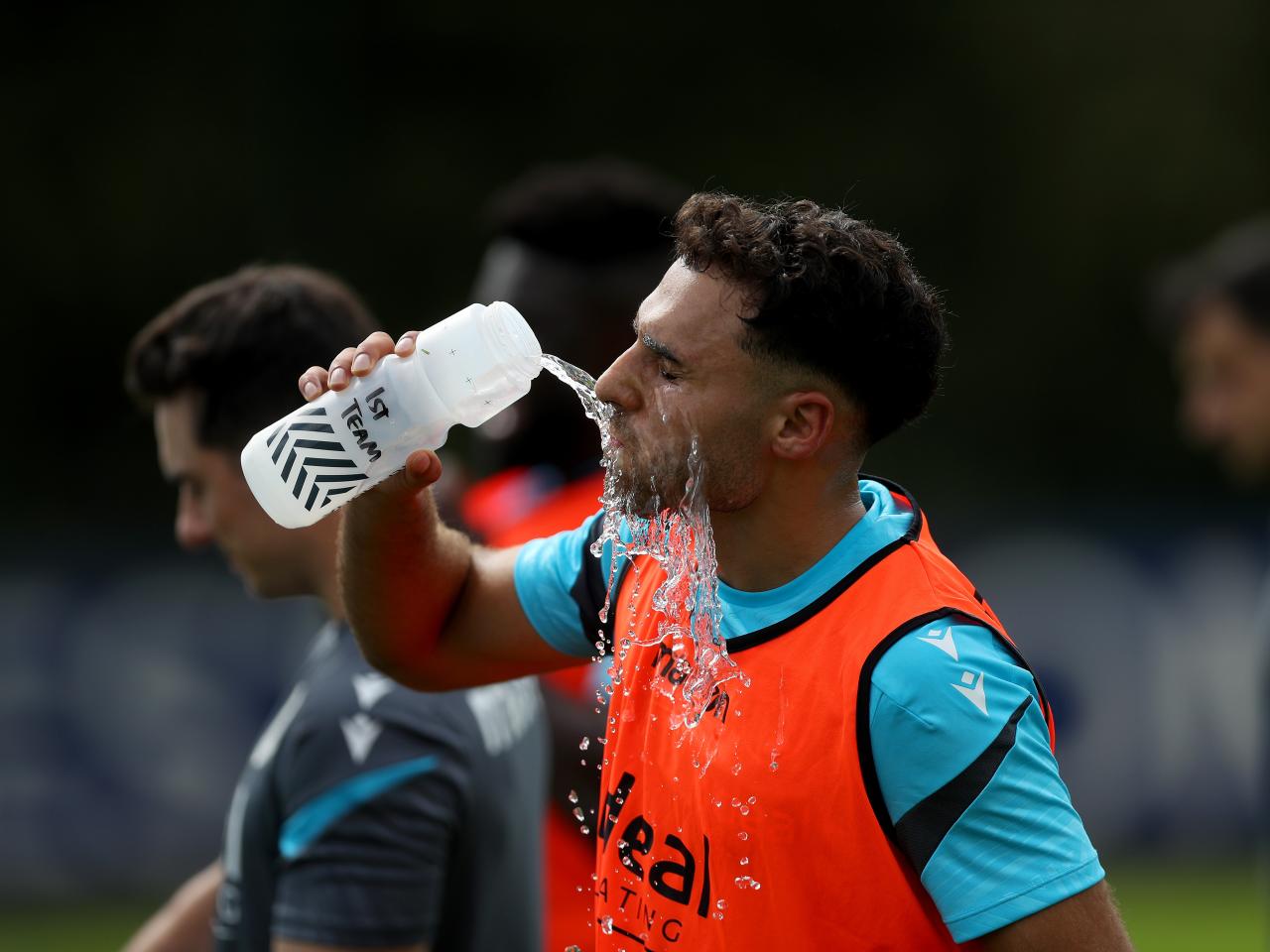 Tammer Bany drinking water during a break in a training session
