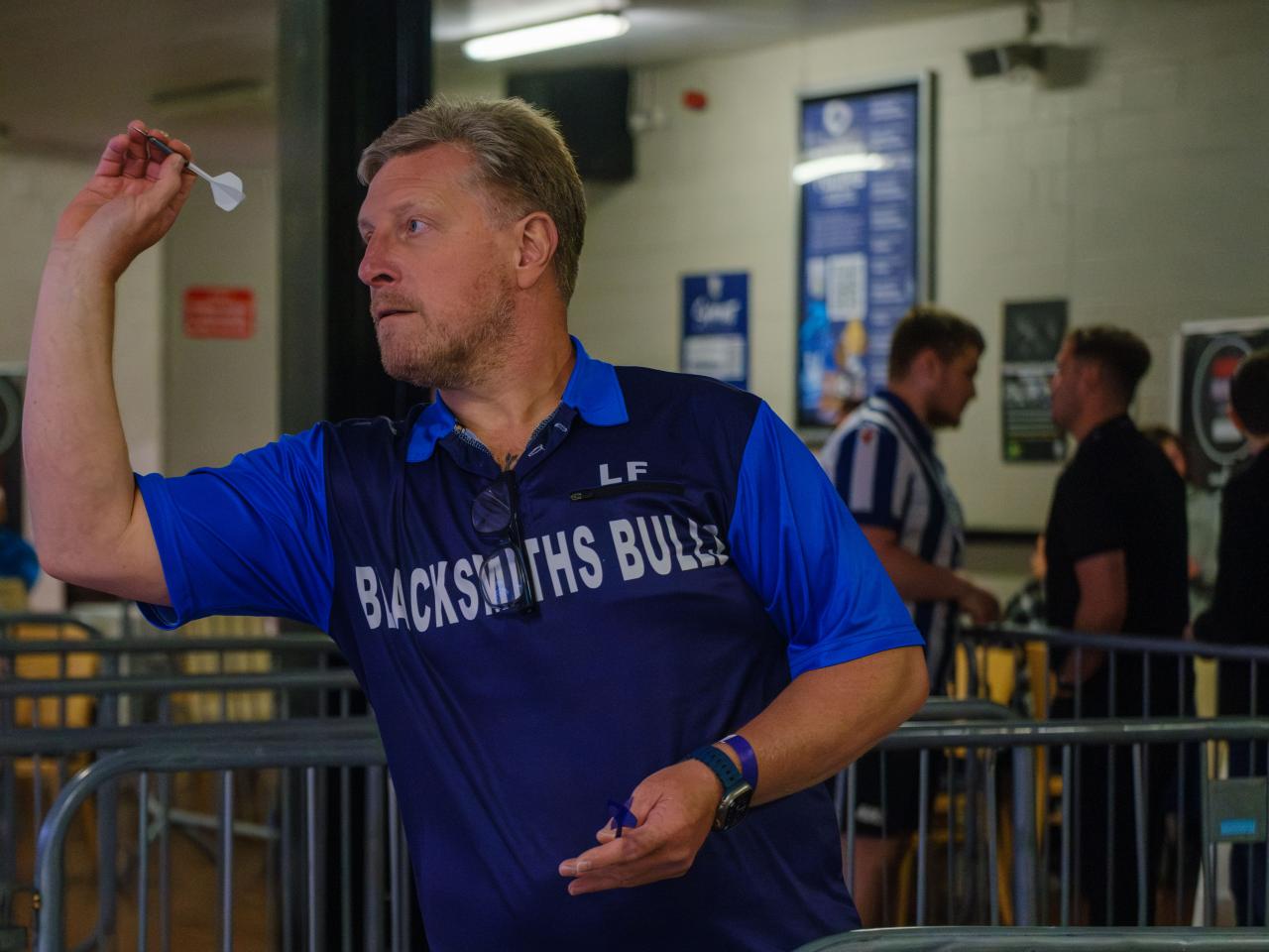 A player takes aim at our darts event.