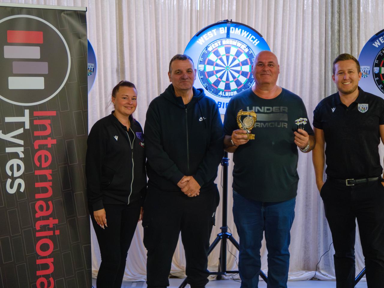 Darts winner Paul Dubberly with International Tyres and The Albion Foundation.