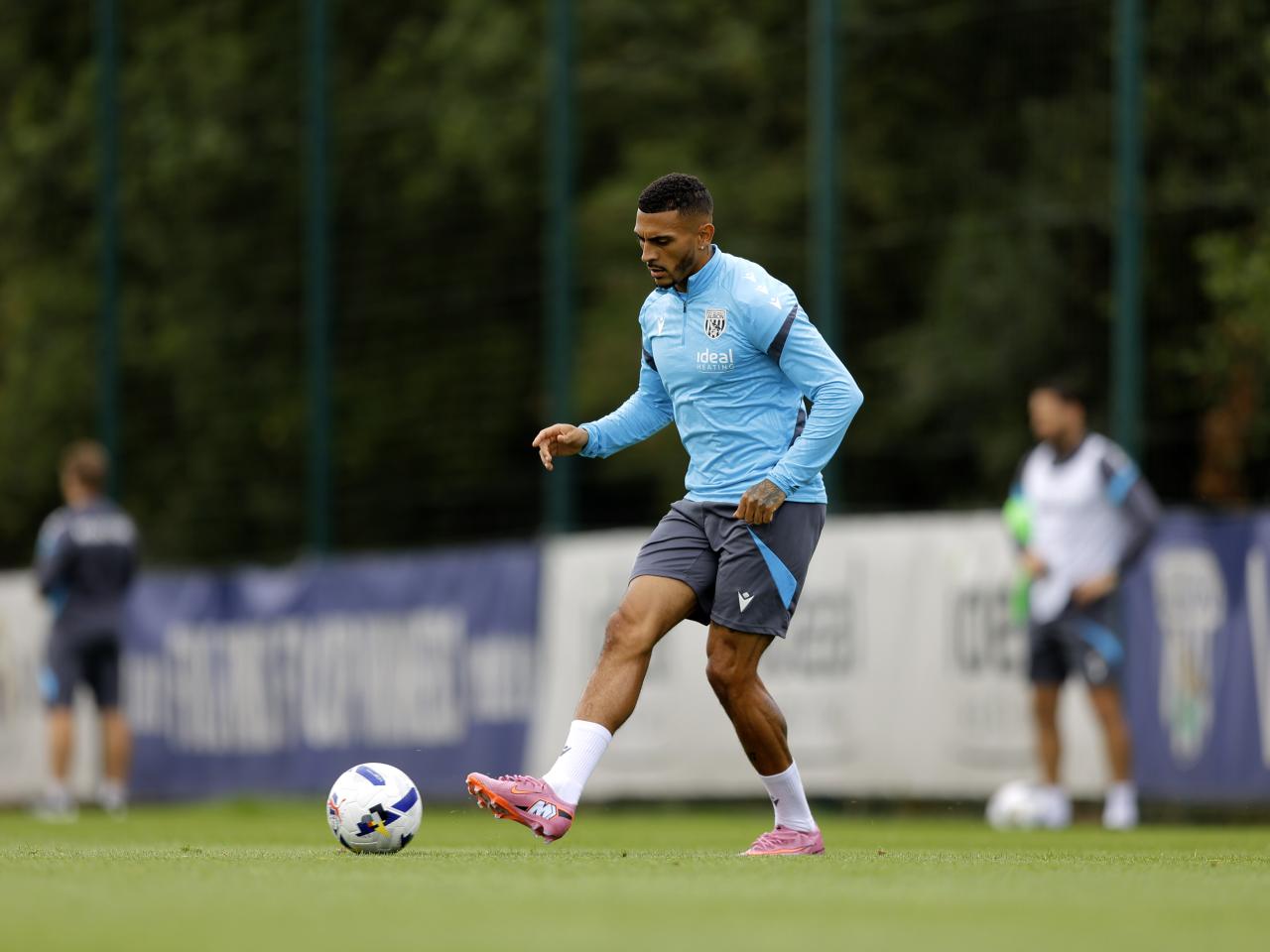 Karlan Grant passing the ball during training
