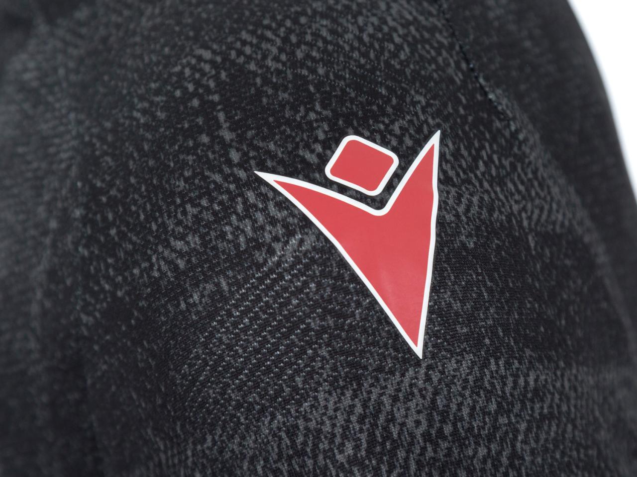 An image of the Macron logo on Albion's black and red third kit