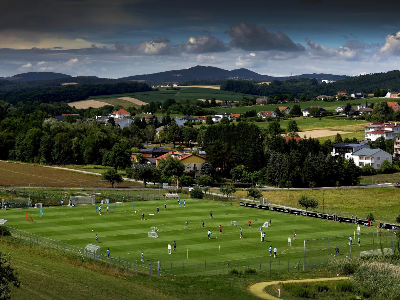 A general view of training from a vantage point with the pitch at the bottom of the hills