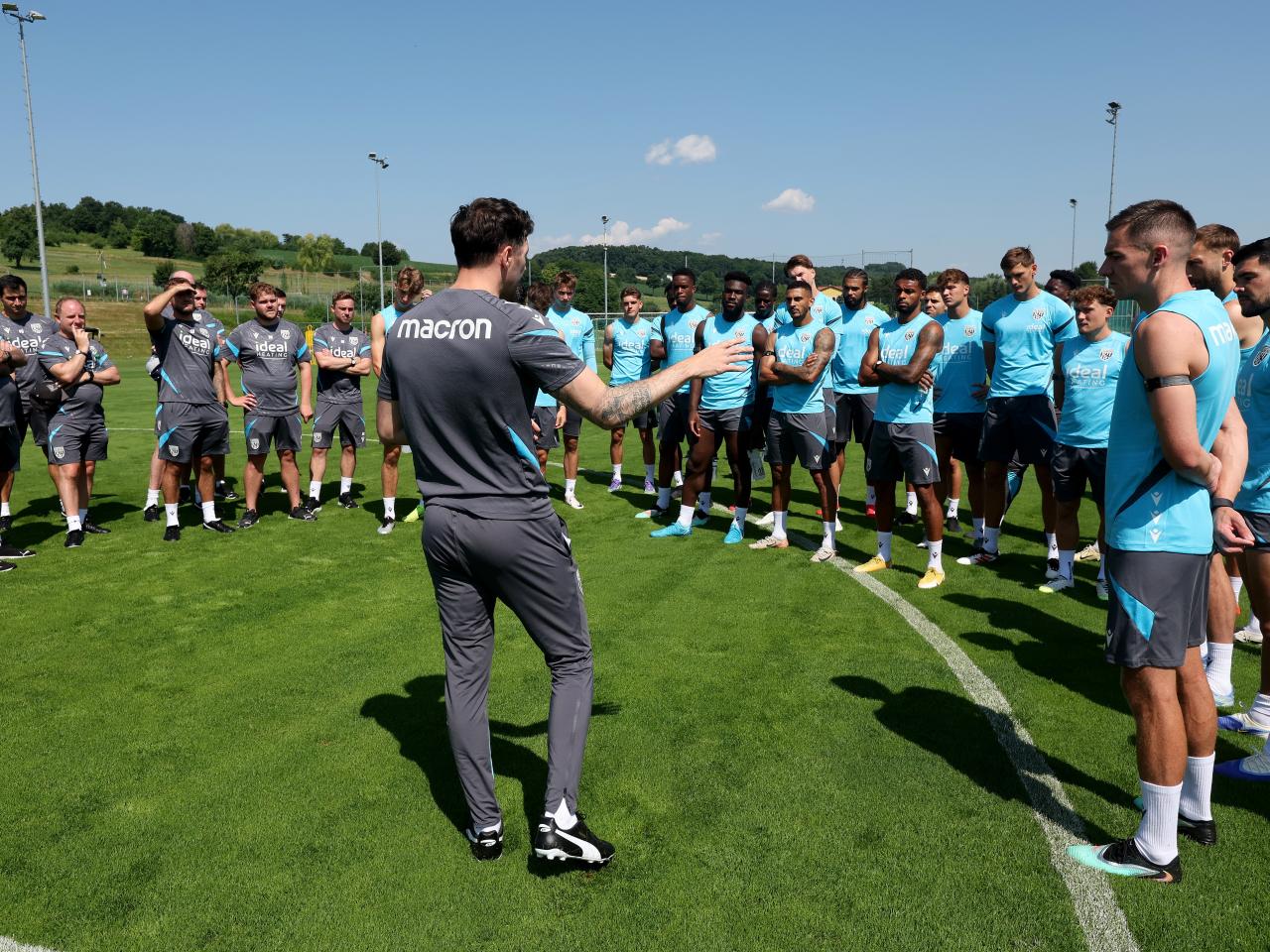 Ryan Mason addressing Albion players and staff on the training pitch before a session