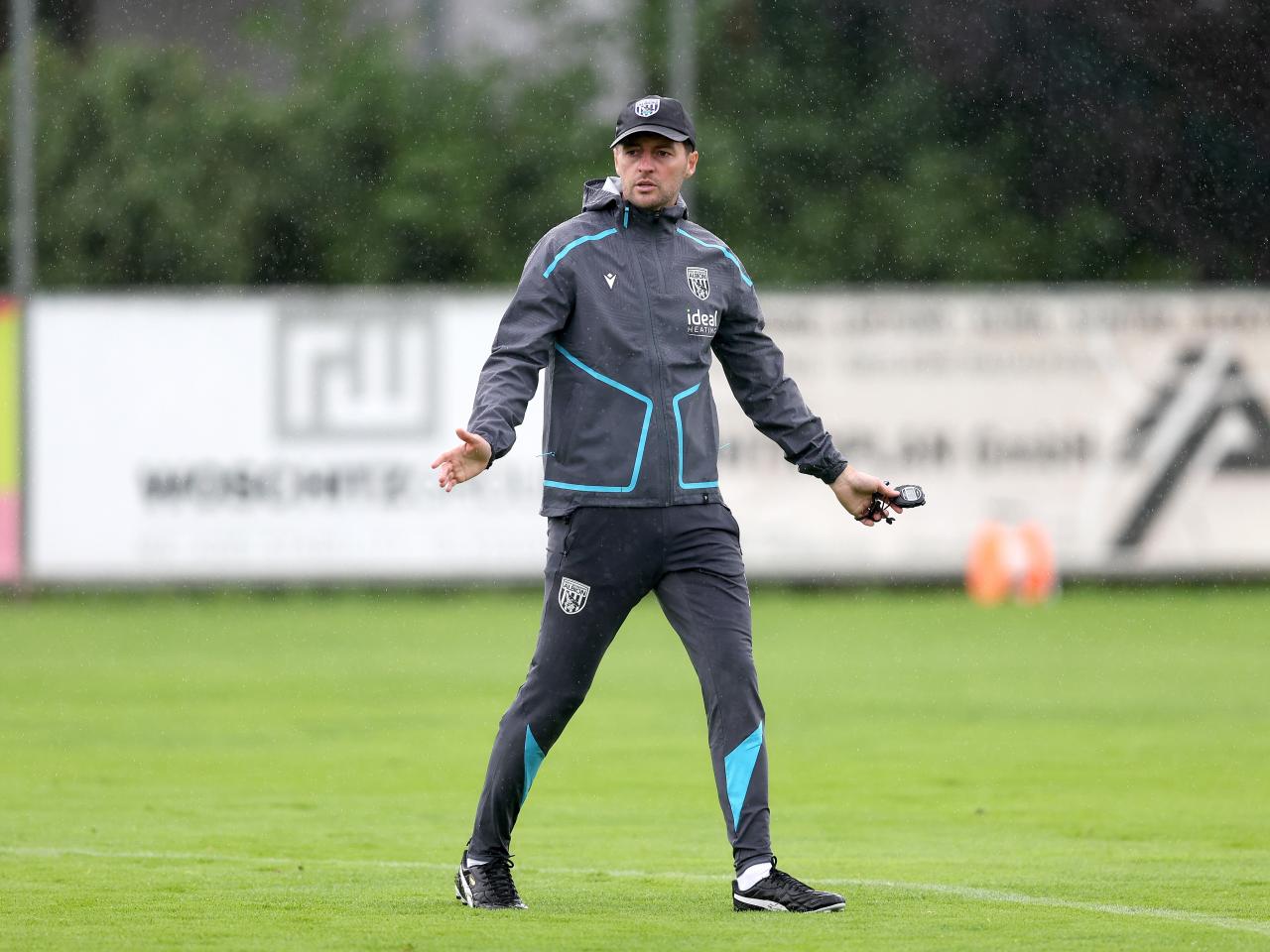 Ryan Mason coaching during a training session in the rain
