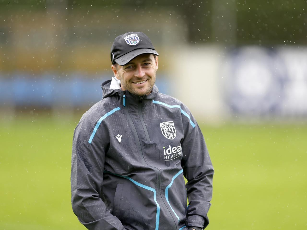Ryan Mason smiling during a training session while wearing a cap