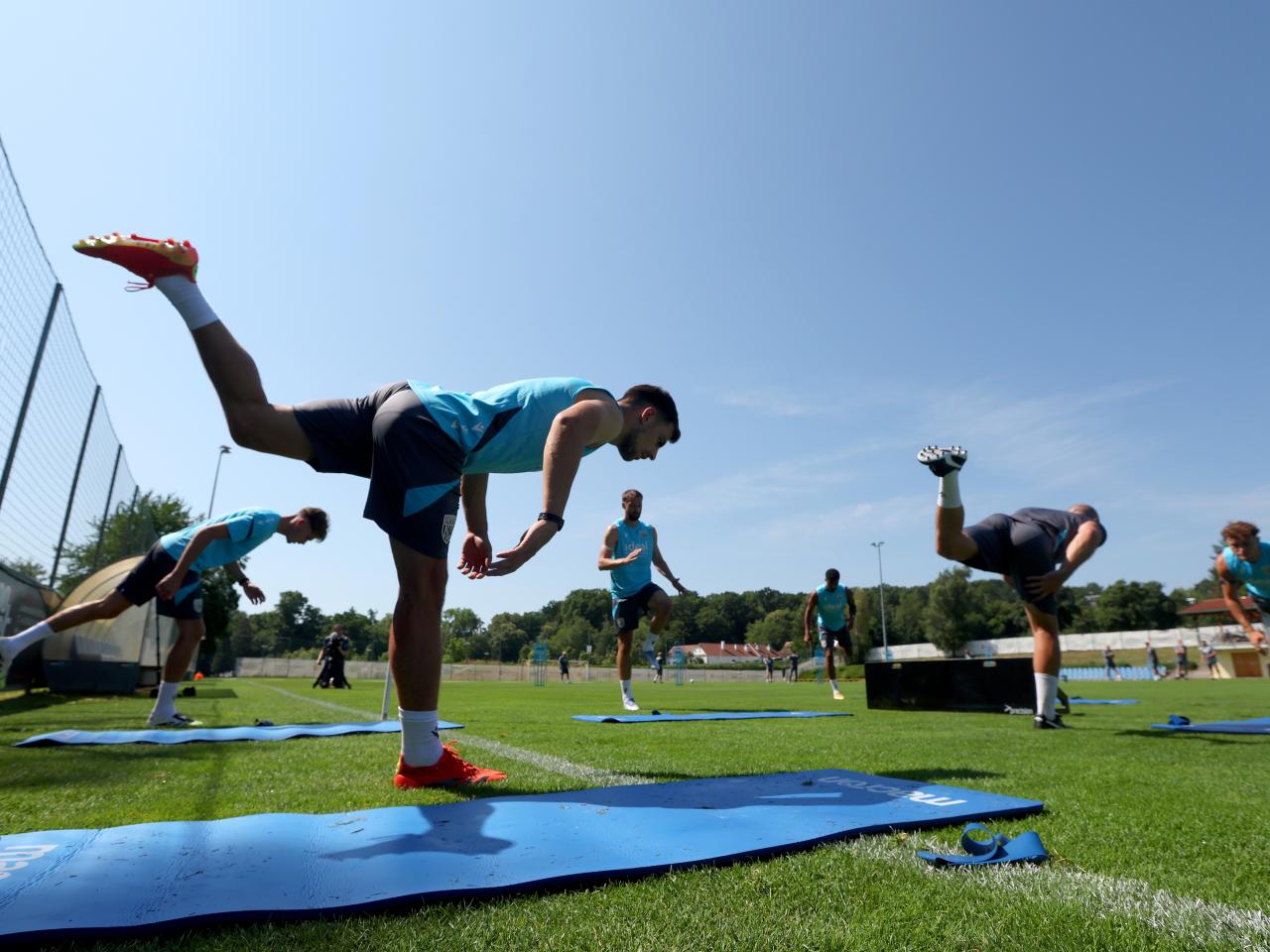 Several Albion players stretching before a training session