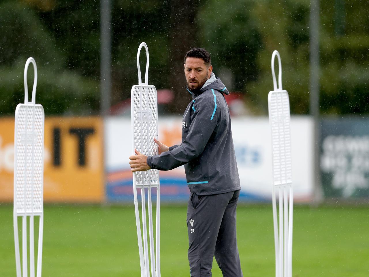 Damia Abella placing down mannequins during a training session