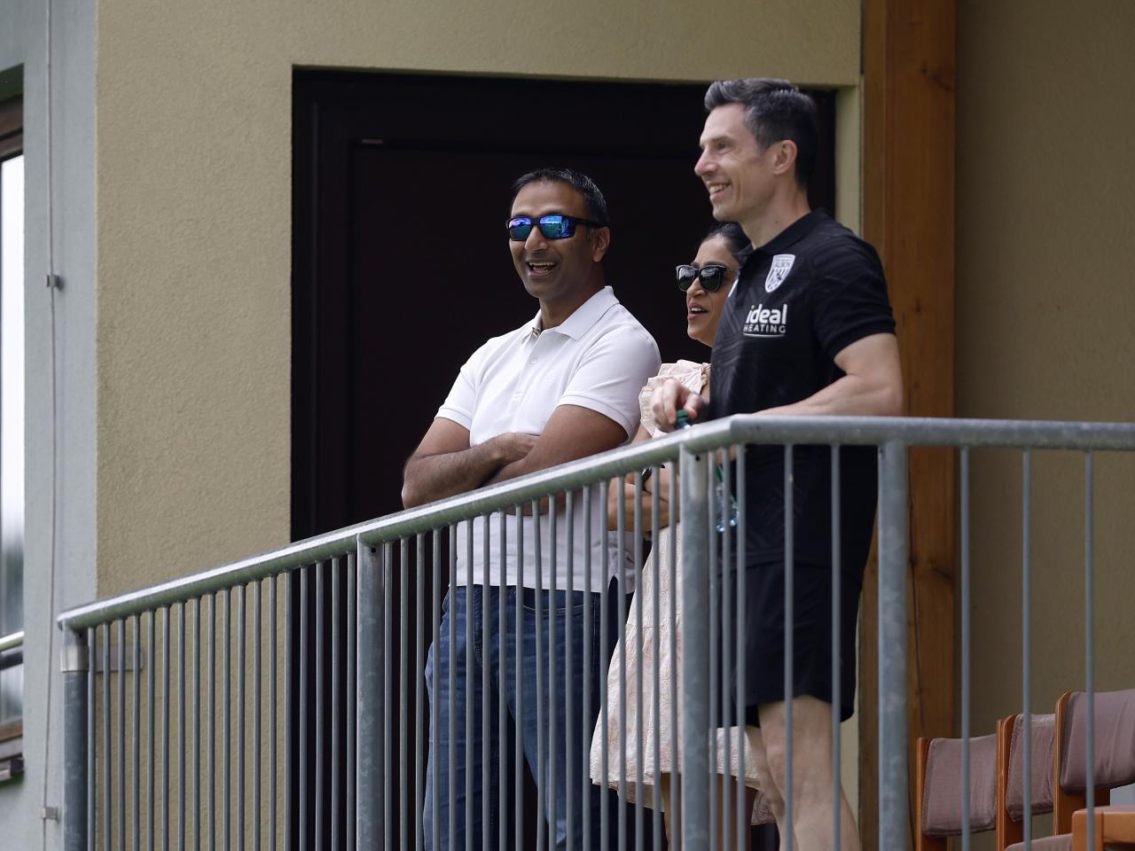 Shilen Patel and Andrew Nestor smiling while watching Albion play Dynamo Kyiv