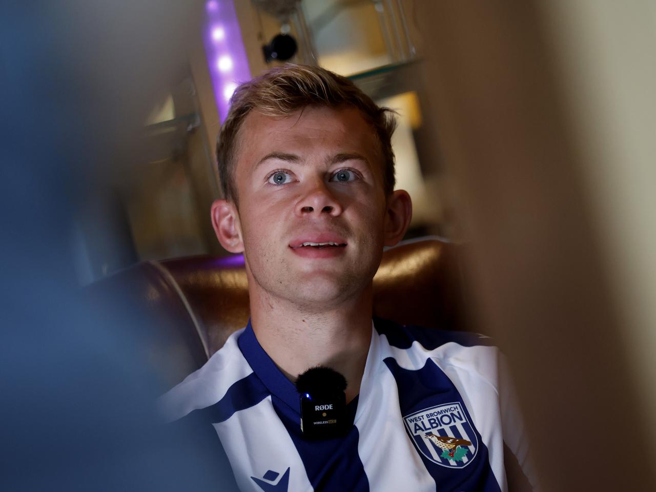 Aune Heggebø smiling while sat in a WBA shirt