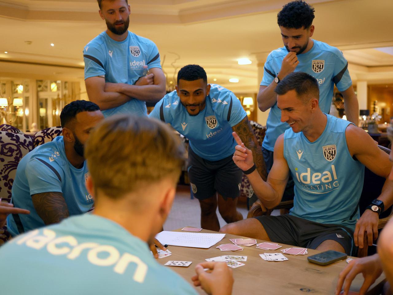 Several Albion players playing cards at a table