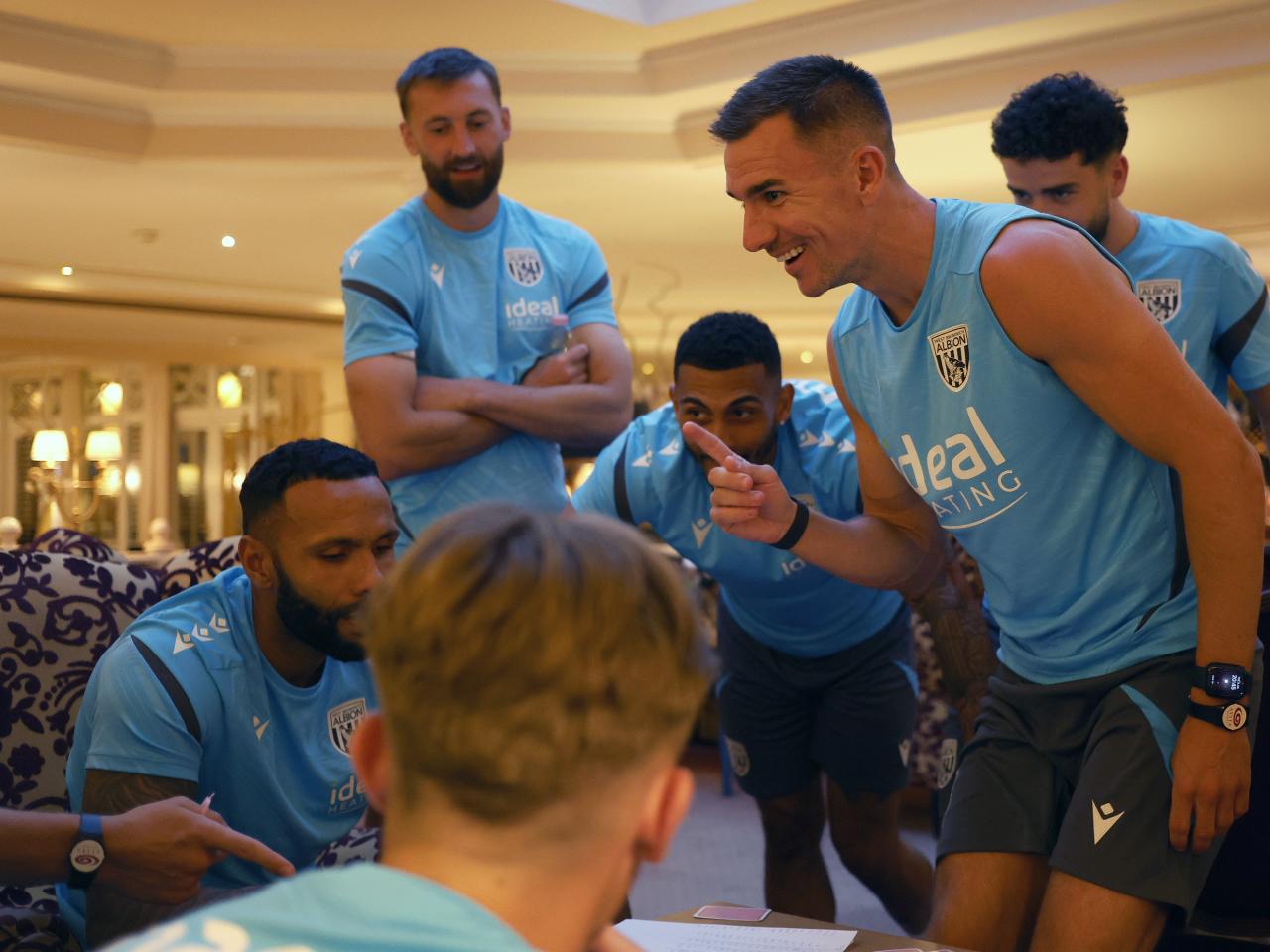 Several Albion players playing cards at a table
